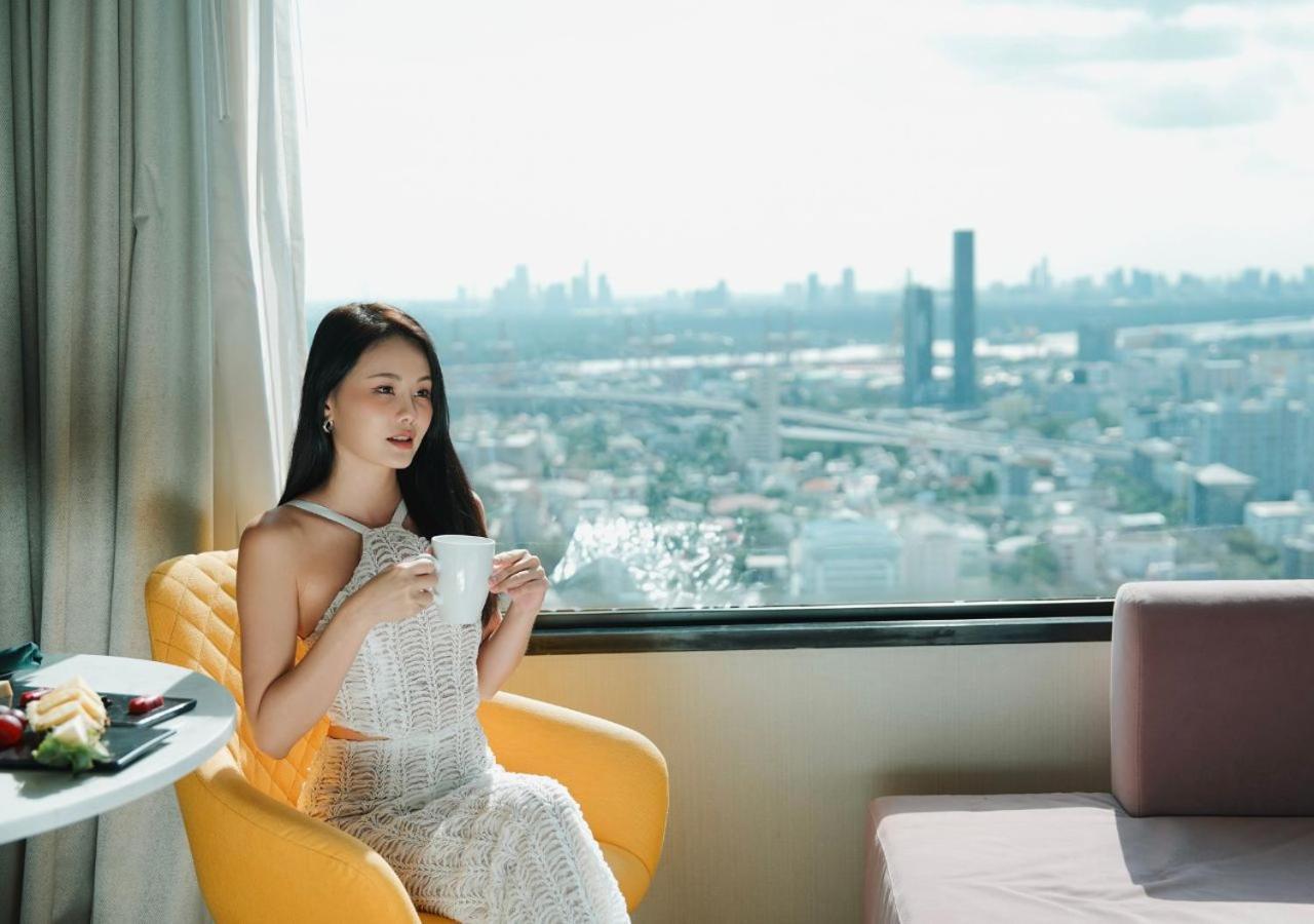 Avani Sukhumvit Bangkok Hotel Exterior foto A woman drinking coffee